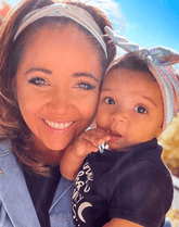 Mom and baby girl are wearing matching mommy and me headbands from By Bella Boutique.